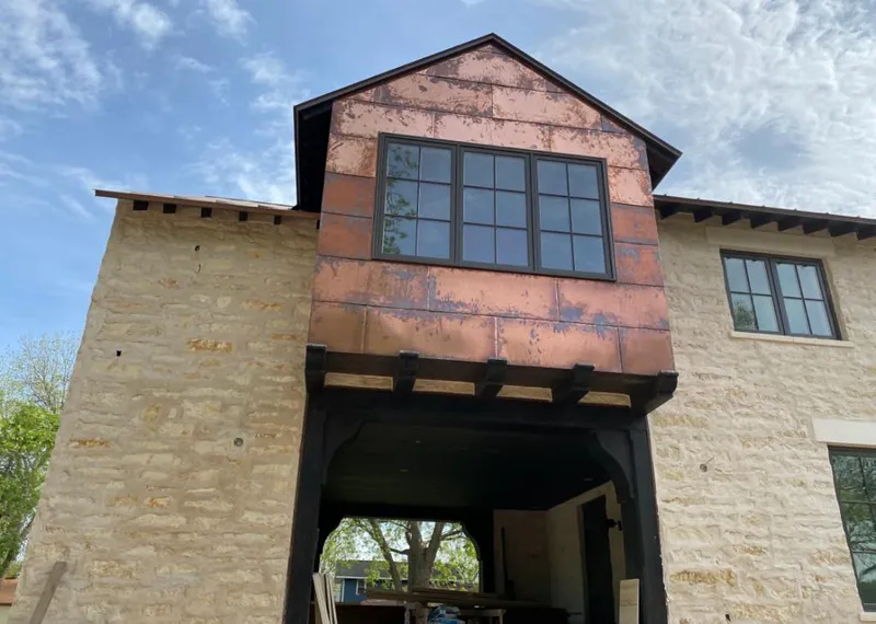 Copper metal panel facade on a stone building for Skylight Installation in Danville